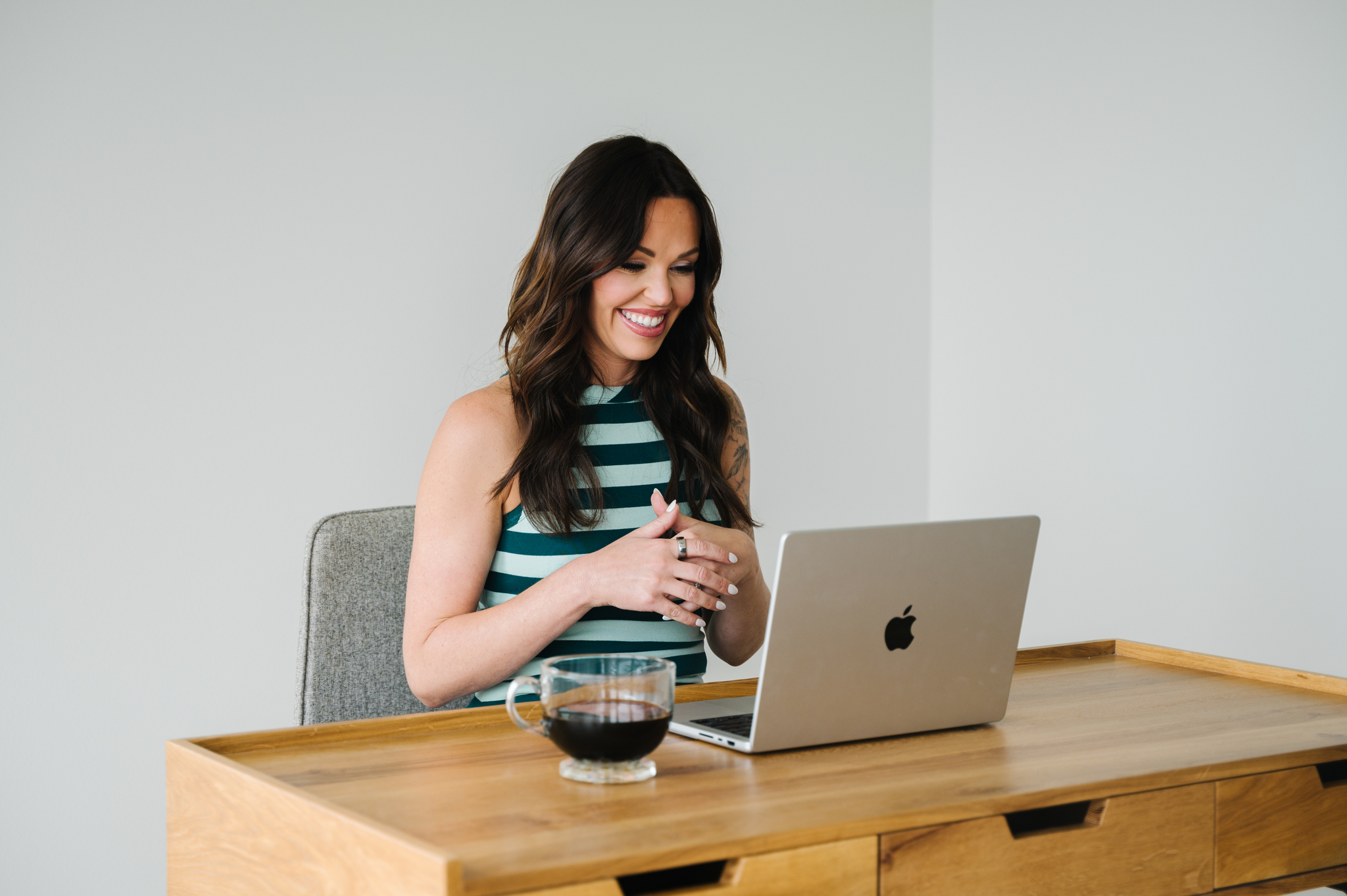 woman conversing to virtual client on laptop