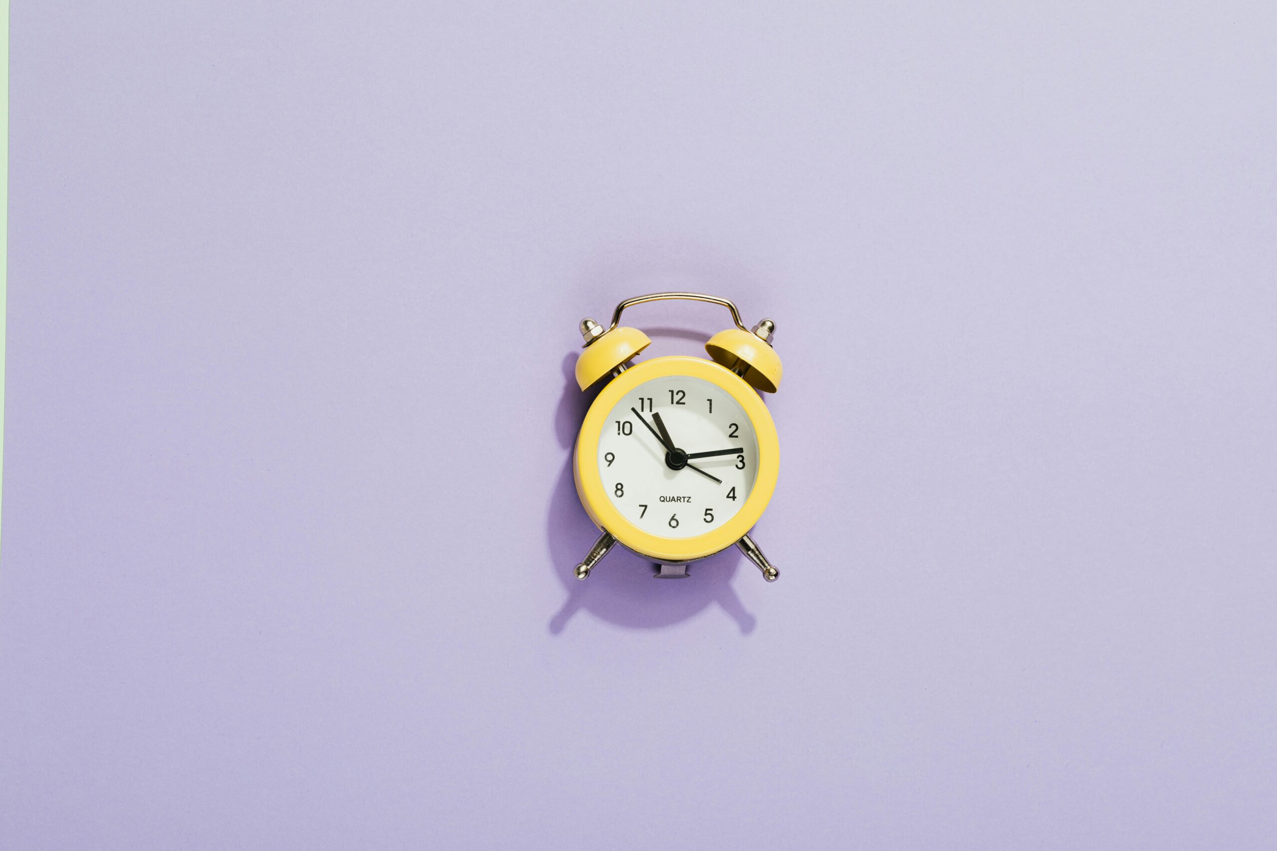 Yellow clock on purple background